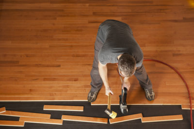 man installing hardwood flooring